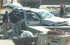 Police gather around a car driven onto the Capitol plaza in Washington Monday, Sept. 18. A man crashed his vehicle into a security barricade at the Capitol, ran into the building and was arrested, forcing the complex to briefly be locked down.