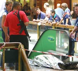 An robber lays dead after alledgedly being shot by a a private security guard during a cash delivery robbery in a shopping center in Johannesburg Monday. Sept. 25 2006. In an annual report released by the police in Pretoria, South Africa, Wednesday Sept