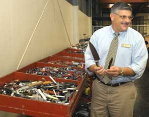 Steve Ekin, director of the Georgia Surplus Property Division, shows some of the items discarded by travelers at Hartsfield-Jackson Atlanta International Airport during security checks, at the surplus property division 'Thrift Store' in Tucker, Ga. Tuesda