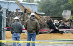 In this Oct. 8, 2006 file photo, inspectors from the Environmental Protection Agency look over the debris at the EQ Industrial Services Inc. plant in Apex, N.C., that was hit by fire on Thursday night Oct. 5, 2006 . State regulators have fined the chemica In this Oct. 8, 2006 file photo, inspectors from the Environmental Protection Agency look over the debris at the EQ Industrial Services Inc. plant in Apex, N.C., that was hit by fire on Thursday night Oct. 5, 2006 . State regulators have fined the chemica