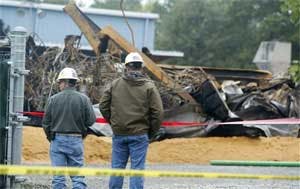 In this Oct. 8, 2006 file photo, inspectors from the Environmental Protection Agency look over the debris at the EQ Industrial Services Inc. plant in Apex, N.C., that was hit by fire on Thursday night Oct. 5, 2006 . State regulators have fined the chemica