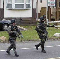 Law enforcement personnel search a mobile home park in Branchburg, N.J. on Thursday, April 5, 2007. The mobile home park is located about three miles south of the PNC bank where an FBI agent was killed in a bank robbery shootout.