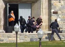 An injured occupant is carried out of Norris Hall at Virginia Tech in Blacksburg, Va., on Monday, April 16, 2007. A gunman opened fire in a dorm and classroom at Virginia Tech on Monday, killing 21 people before he was killed, police said.