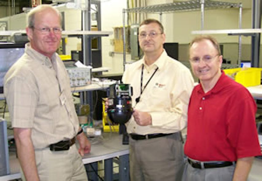 Left to right: Frans Pross, former vice president, Global Service and Repair; Gary Jackson, Technical Repair Supervisor; and David Urech, vice president, Global Service and Repair, with the first AutoDome unit serviced at the consolidated repair center.