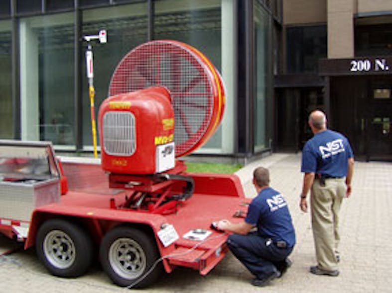 NIST fire researchers Stephen Kerber and Roy McLane position a mounted fan outside the doorway of a 30-floor building in Toledo, Ohio. The positive pressure ventilation (PPV) experiment demonstrated that in a building with sprinklers, the fan, operating a