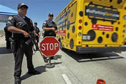 Los Angeles International Airport Police James Montano, left, holding a machine gun stands guard at a checkpoint at the entrance of the airport in Los Angeles Monday, July 2, 2007. Security measures were tightened in some U.S. airports since Saturday afte Los Angeles International Airport Police James Montano, left, holding a machine gun stands guard at a checkpoint at the entrance of the airport in Los Angeles Monday, July 2, 2007. Security measures were tightened in some U.S. airports since Saturday afte