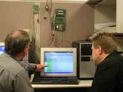 Developers work with the Automated Test system, showing the green status light.