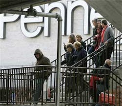 People walk down stairs to evacuate from the Westroads Mall after a gunman opened fire at a Von Maur store in the complex in Omaha, Neb., Wednesday, Dec. 5, 2007. At least one person was wounded and police locked down the shopping center while they search