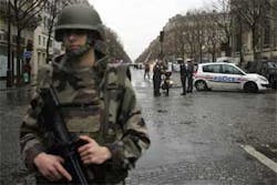 A soldier blocks the access to the boulevard near the scene of an explosion in Paris, Thursday, Dec. 6, 2007, in which one person was killed and another seriously injured, according to the Interior Ministry.