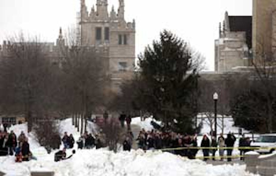Under the spires of Altgeld Hall, Northern Illinois University community members gathered near Cole Hall after word of the campus shooting spread through the university Thursday Feb. 14, 2008. A man opened fire with a shotgun and a handgun wounding severa