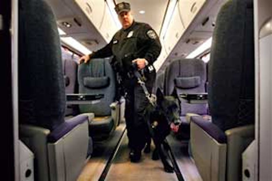 Amtrak police officer Joe Zawacki demonstrates a search for explosives with a dog on an Amtrak train as part of a demonstration of new security sweeps at Union Station in Washington on Friday, Feb. 15, 2008. Amtrak passengers will have to submit their car