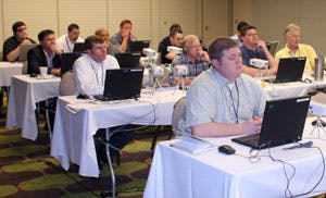 Participants delve into set-up of software for license plate recognition during the recent MIPS 2008 program.