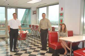The 1950s diner style break room (a past theme of the company's tradeshow booth) is part of the new offices for Stanley Convergent Security Solutions. Left to Right: Jim Kopplin, Regional Vice President &Acirc;&ndash; Central (Aurora, IL); Tony Byerly, Chief Operati