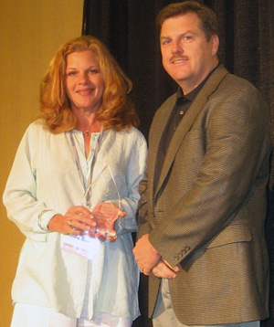 Current IQ Certification Chairperson Tim Creenan (right) presents former Chairperson Lisa Prosser (left) with a plaque in recognition for her dedication and contributions to the program at last month&Acirc;&rsquo;s ESX show in Nashville, Tenn.