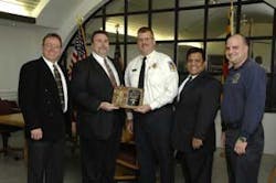 (l-r) Kevin Lehan (EM24), Sam Splaine (Splaine Security Systems), CJPVFD Chief James Seavey, Bernie Ramos (EM24) and CJPVFD Vice President David Cohen pose together with a plaque that commemorates the Responder Reward Donation. (l-r) Kevin Lehan (EM24), Sam Splaine (Splaine Security Systems), CJPVFD Chief James Seavey, Bernie Ramos (EM24) and CJPVFD Vice President David Cohen pose together with a plaque that commemorates the Responder Reward Donation.