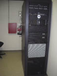 Access control and surveillance head-end equipment shown mounted in a 19-inch server rack alongside facility voice/data network gear.