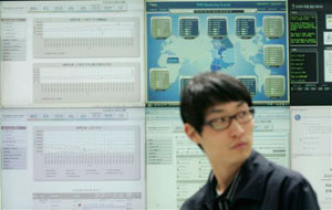 An employee of Korea Internet Security Center looks on while working at a monitoring room in Seoul, South Korea, Wednesday, July 8, 2009. South Korean intelligence authorities believe that North Korea or pro-Pyongyang forces in South Korea committed cyber