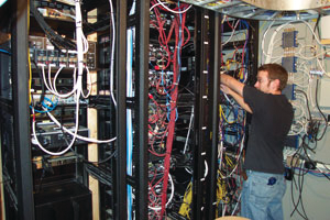 Audio Video Design&rsquo;s Technician Mike Kirby dresses wires at a customer location.