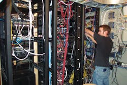 Audio Video Design’s Technician Mike Kirby dresses wires at a customer location. Audio Video Design’s Technician Mike Kirby dresses wires at a customer location.
