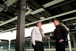 Left, Tony Belotto, Division Manager, Hypower Security Services, confers with Bruce Price, Sony Security Systems representative from Tronex Co. about the camera installation.