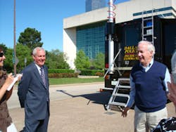 Left, Martin Cramer of Downtown Dallas Inc. and John Watson, chairman of BearCom and integrator on the camera solution deployed in Dallas, flank the impressive tactical Mobile Command Center (MCC) purchased by the city to enhance its surveillance operations.
