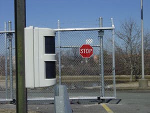 Outdoor motion detector strategically placed by an entrance gate detects thieves attempting to bring large vehicles onto the premises.