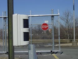 Outdoor motion detector strategically placed by an entrance gate detects thieves attempting to bring large vehicles onto the premises.