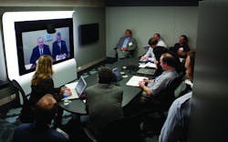 In a teleconference from ADT&rsquo;s Integrated Solutions Center in Colorado, (from left on screen) ADT Director of Integrated Strategy Jim Lantrip and Cisco Physical Security Business Unit Vice President Bill Stuntz address security media members gathered in Chicago for the ADT Media Summit.