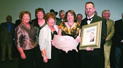 Michael Miller and his wife Debby display his 2010 Morris F. Weinstock Person of the Year Award and the latest issue of Newsline which features him on the cover. His sisters (left to right) Laurel Heinemann, Jolene Nelson and his mother Ruth Ann Pound surprised Miller at the awards ceremony. Past recipients of the Weinstock award were on stage to honor Miller on his accomplishments.