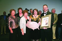 Michael Miller and his wife Debby display his 2010 Morris F. Weinstock Person of the Year Award and the latest issue of Newsline which features him on the cover. His sisters (left to right) Laurel Heinemann, Jolene Nelson and his mother Ruth Ann Pound surprised Miller at the awards ceremony. Past recipients of the Weinstock award were on stage to honor Miller on his accomplishments.