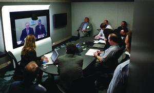In a teleconference from ADT's Integrated Solutions Center in Colorado, (from left on screen) ADT Director of Integrated Strategy Jim Lantrip and Cisco Physical Security Business Unit Vice President Bill Stuntz address security media members gathered in Chicago for the ADT Media Summit.