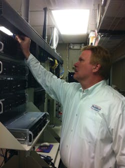 Randy Arras, network and IT manager at ProTech Security, works in their main frame room.
