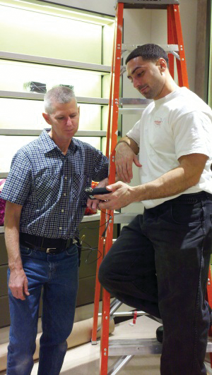 Amerigard technicians Dan Foley and James Pinto work on an installation at Bottega Veneta on Madison Ave., New York City.