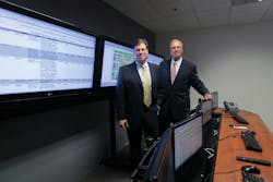 Craig and Al Albrecht pose in their Security Network Operations Center where they monitor and support their clients.