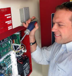 ASG Security Sales Consultant, Justin MacDaniel, installs Honeywell IPGSM-DP fire alarm communicator at a luxury apartment complex.