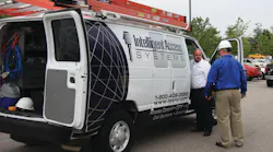 Derek Bischoff and Tim Bullock (blue shirt) load up for a day’s work out of the Raleigh office of Intelligent Access Systems.