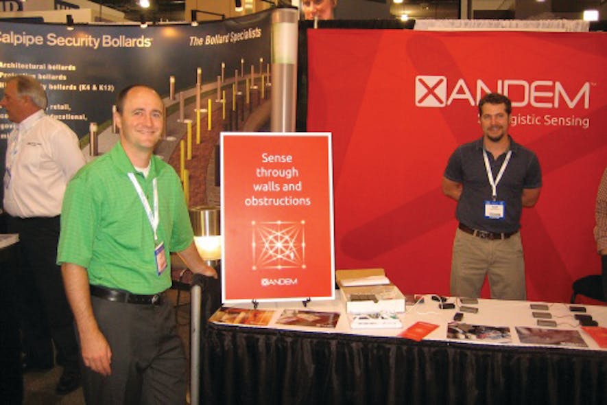 Dr. Joey Wilson (left) stands in front of the Xandem booth at ASIS 2012. The company is showcasing its Tomographic Motion Detection at the show this week.