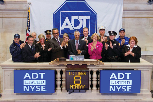 Members of ADT's senior leadership team ring the opening bell at the New York Stock Exchange on Monday, Oct. 8, 2012.