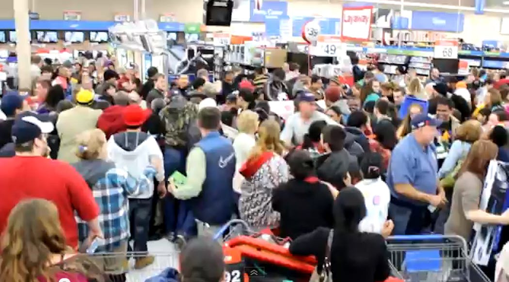 An out-of-hand Walmart Black Friday 2012 crowd pushes, shoves and fights for bargains.