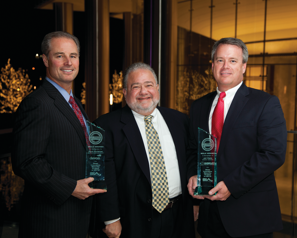 Devon Energy Security Director Kent Chrisman (left) and Jeff Fields, General Manager of integrator Dowley Security Systems (right), accept the 2012 STE Security Innovation Awards gold medal from Editorial Director Steve Lasky (middle).