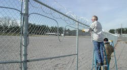 Integrators install detection on a perimeter fence.