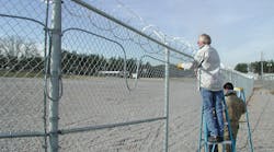 Integrators install detection on a perimeter fence. Integrators install detection on a perimeter fence.