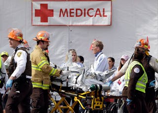 Medical personnel work outside the medical tent in the aftermath of two blasts which exploded near the finish line of the Boston Marathon on April 15.