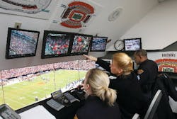 Cleveland police officers monitor cameras they control from the Operations Center at Cleveland Browns Stadium. Cameras throughout the stadium can be operated by joystick to pivot and zoom in on fans to detect problems.