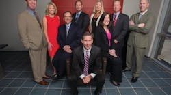 Protection 1 Chairman and CEO Tim Whall, center, surrounded by the company&apos;s leadership team.
