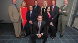 Protection 1 Chairman and CEO Tim Whall, center, surrounded by the company's leadership team.