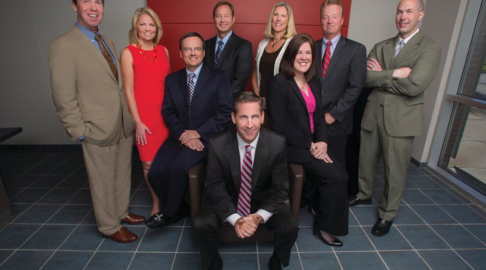 Protection 1 Chairman and CEO Tim Whall, center, surrounded by the company&apos;s leadership team.