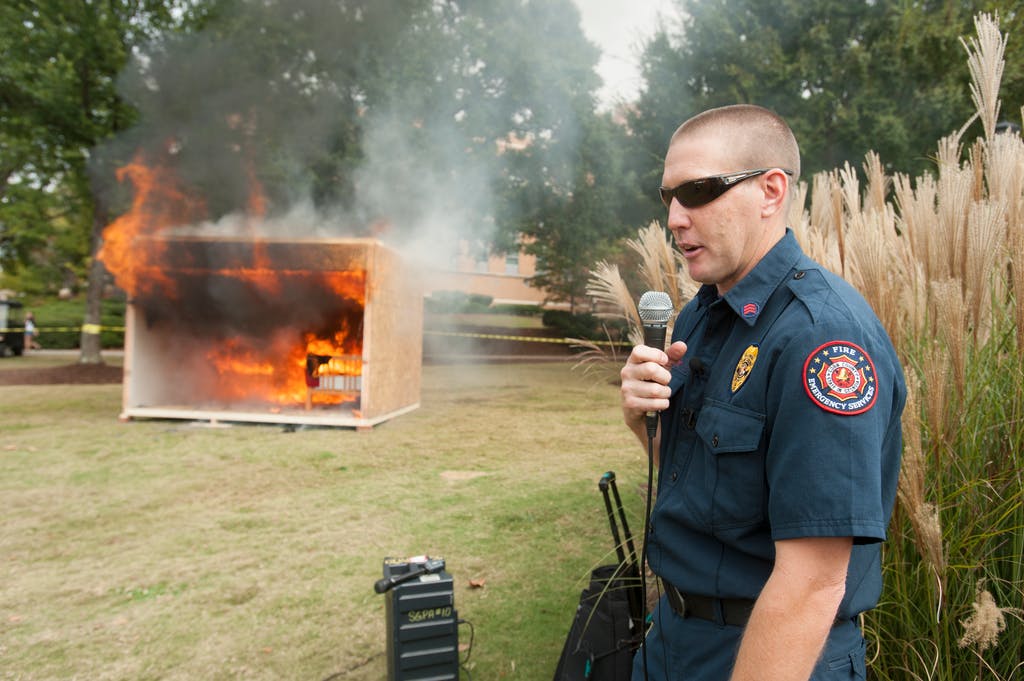 KSU facilities personnel constructed a mock dorm room with supplies donated by The Home Depot. For maximum visibility, it was situated on a busy corner of the Campus Green near the main entrance to the Carmichael Student Center. Combustible items such as bedspreads, curtains, books and notebook paper fueled the fire, which was ignited when a lighted candle fell into a trashcan in the room.