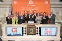 Allegion Chariman, President and CEO Dave Petratis (center) rings the opening bell at the New York Stock Exchange on Monday with other company executives.