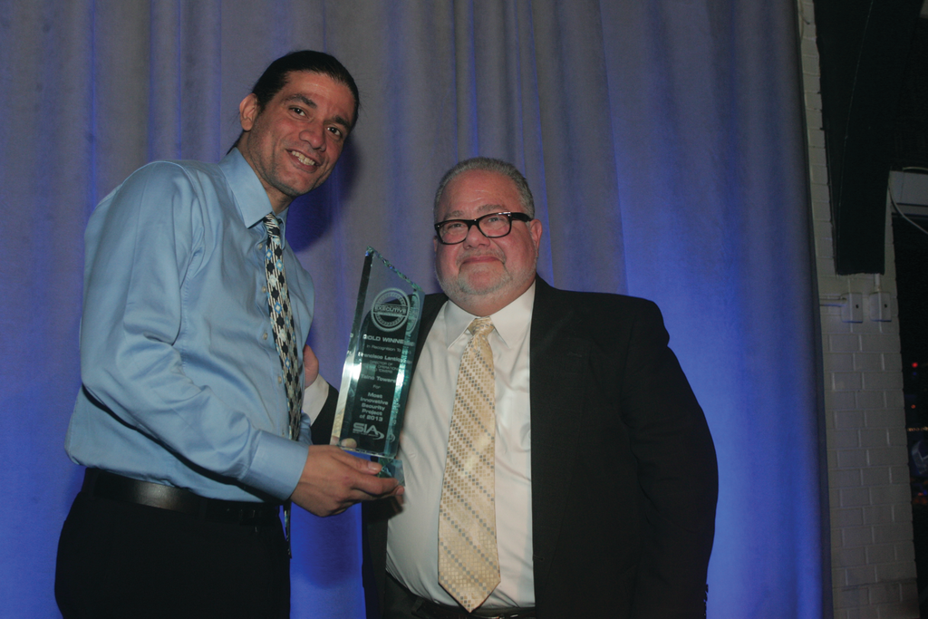 Francisco Lantigua, the Director of Security Operations for Taino Towers, receives the Gold from editorial director Steve Lasky for the 2013 STE Security Innovation Awards.